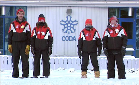 Snowshoers standing in front of Canada Olympic Development Association building
